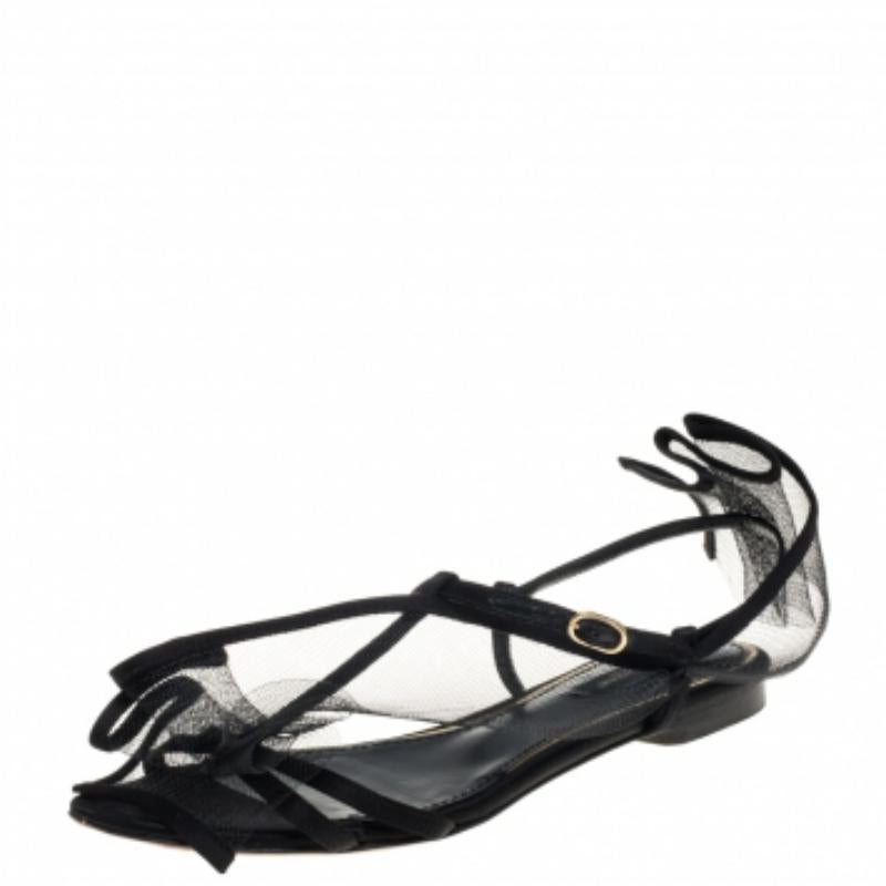 These magnificent flats from Dolce & Gabbana are designed to complement your entire outfit. These satin flats will lend an elegant and poised look. They come in a lovely shade of black and are detailed with a mesh overlay. They have buckled ankle