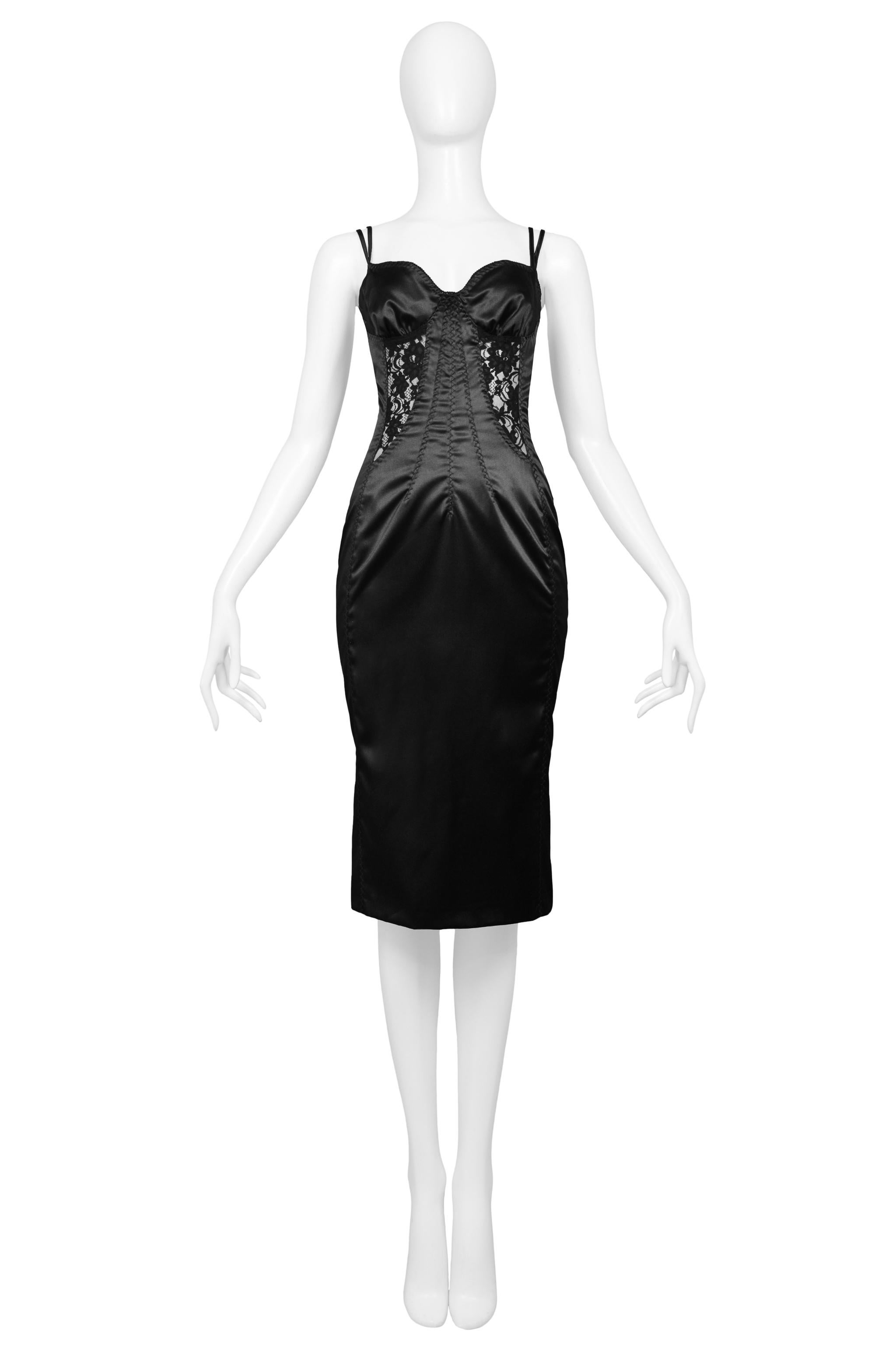 Resurrection Vintage is excited to offer a vintage Dolce & Gabbana D&G collection black bodycon lingerie-inspired dress featuring bra, corset, and girdle detailing, satin finish stretch fabric, double straps, center back zipper and knee length.