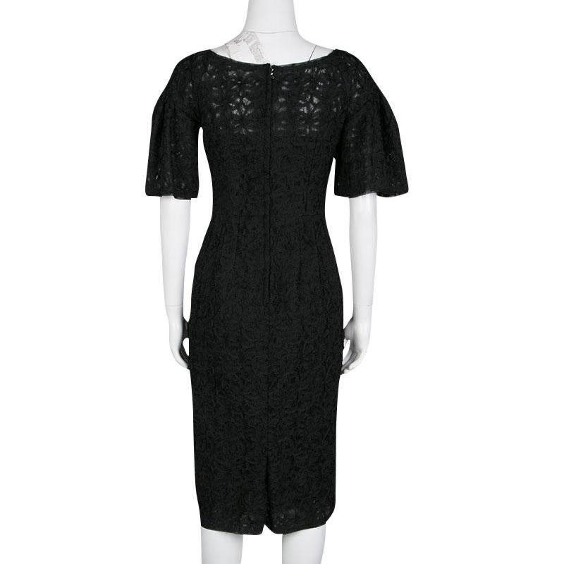 Graced with a gorgeous silhouette, this Dolce And Gabbana dress is second to none in terms of style, class, and comfort. A sophisticated piece, the outfit is appliqued by striking lacework and has flouncy sleeves. A rear slit and zip closure