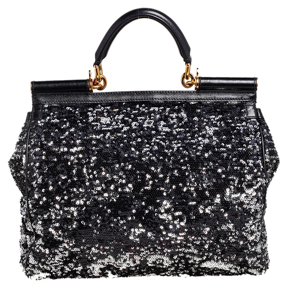 The iconic Miss Sicily bag by Dolce & Gabbana is named after Domenico Dolce's native land and exhibits the aesthetic of Italian glamour. The neat silhouette is made from sequins in a black shade and features a front flap accented with the signature