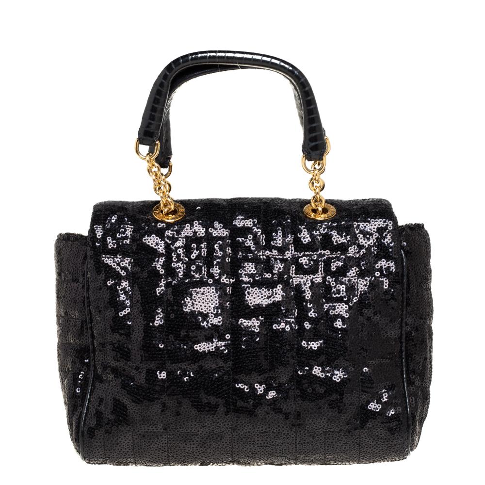 This gorgeous Sicily bag from Dolce & Gabbana is a handbag coveted by women around the world. It has a well-structured design and a flap that opens to a compartment with satin lining and enough space to fit your essentials. This sequins bag comes