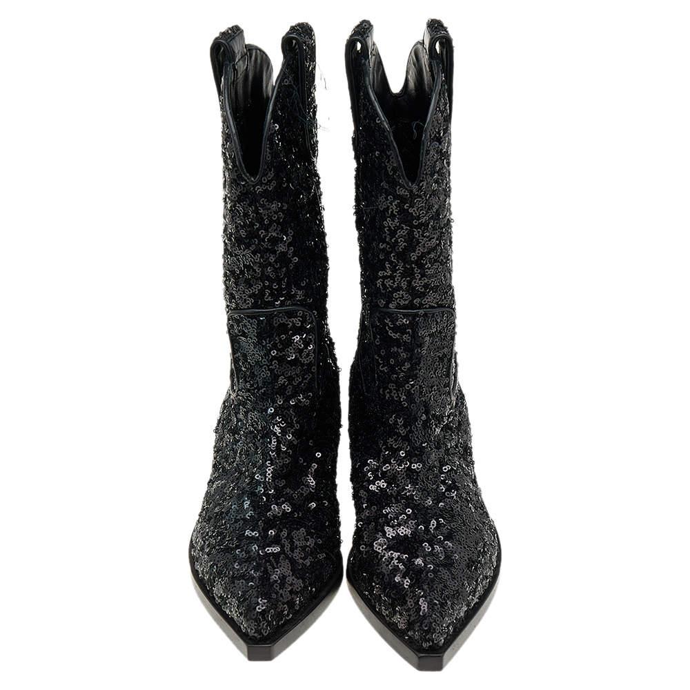The true beauty of these glamorous Dolce & Gabbana boots is that they will never really go out of style. Adorned with sequins, these black boots define the brand's fashionable spirit. They are finished off with low heels and pointed-toes for an