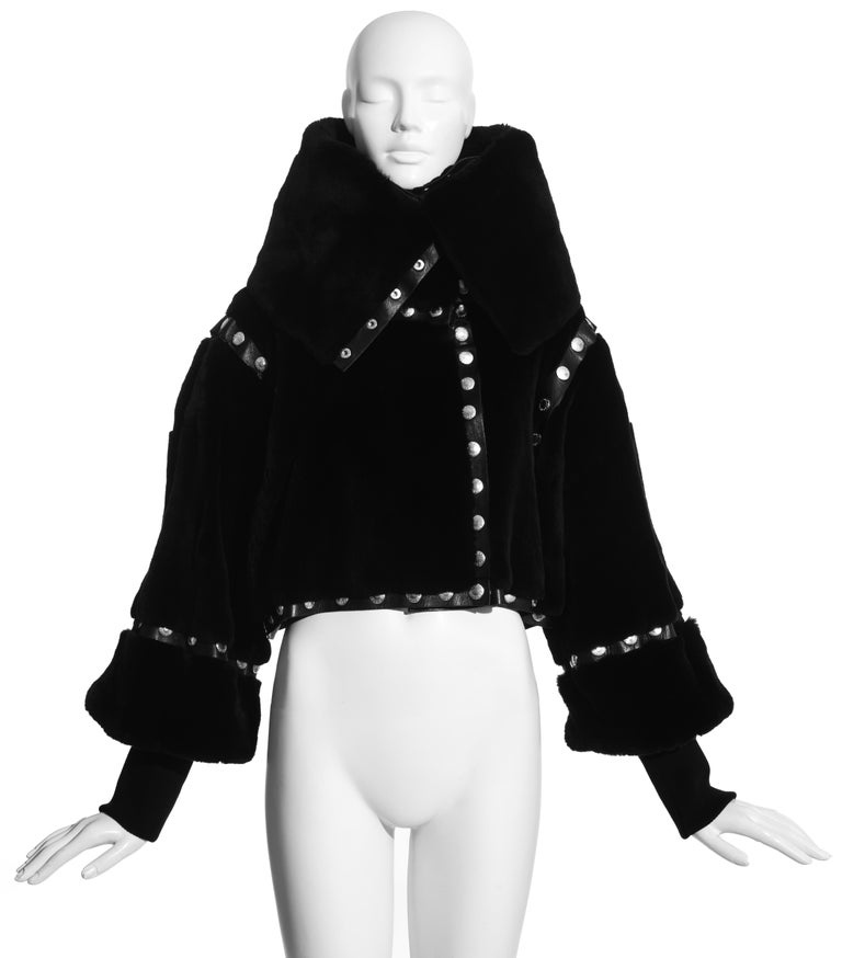 Dolce & Gabbana black sheared fur and leather cropped jacket constructed with six individual panels attached with silver snap fastenings.

Fall-Winter 2003

