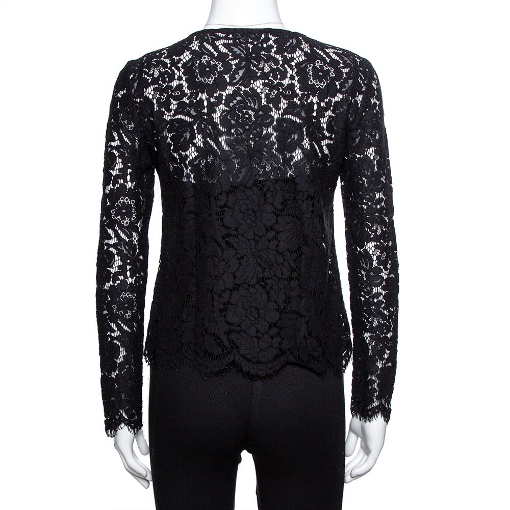 This Dolce & Gabbana top is an essential addition to your wardrobe. Made from lace fabric, this piece is simple yet stylish. The black color will allow you to experiment with accessories. The long sleeves complete the look. Wear this top with