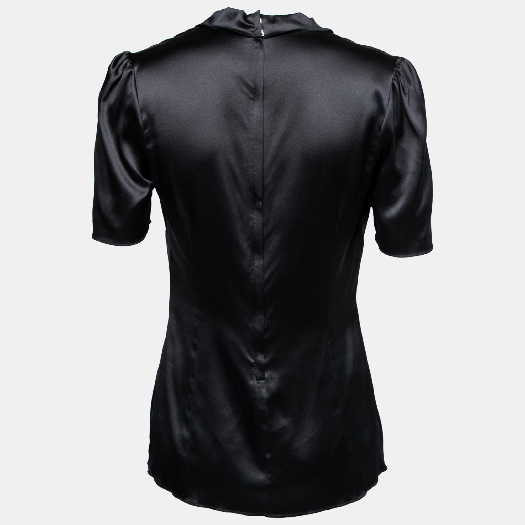 The house of Dolce & Gabbana brings you this super-stylish, sleek blouse for your evening wear. Crafted meticulously with silk satin, it comes with short sleeves and a zip closure. The flattering silhouette of the black blouse will look lovely with