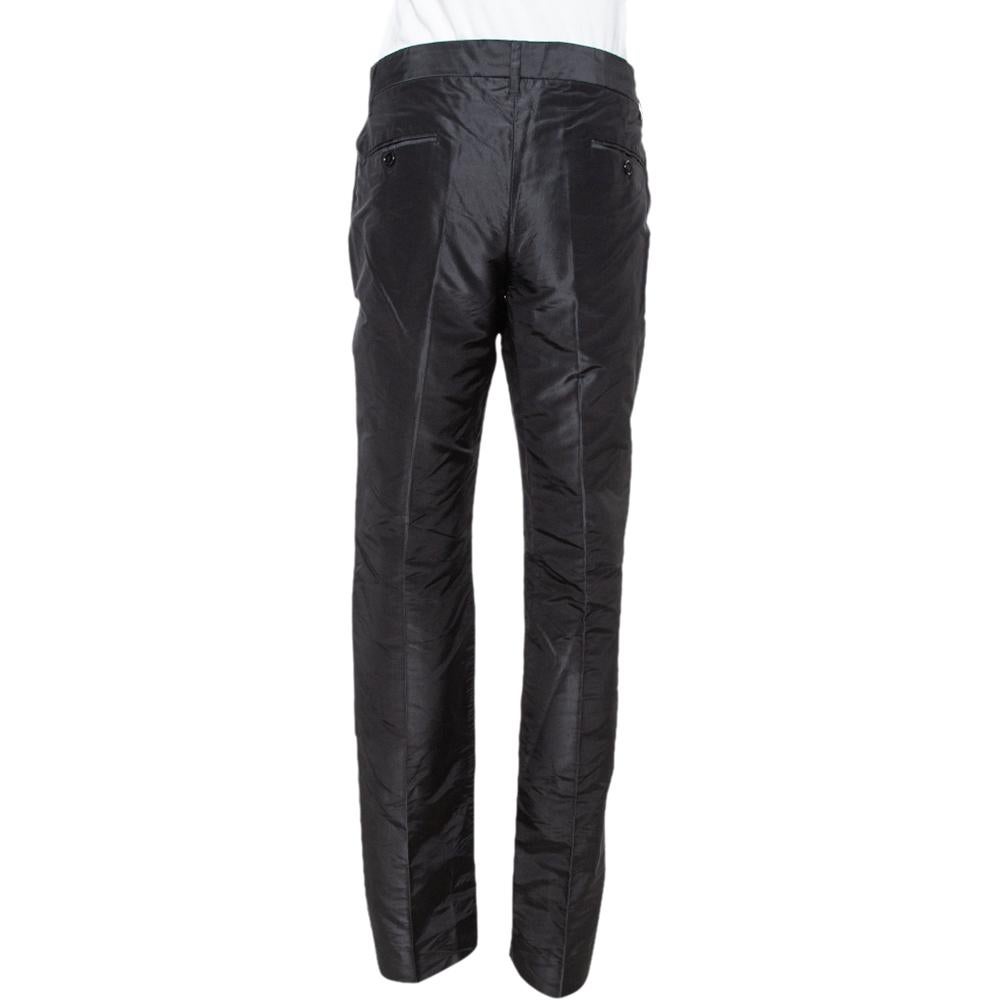 Silk-made, the black Dolce & Gabbana pants offer a straight fit. They are equipped with belt loops, zip closure, and four pockets. Style them with simple tops and high heels.

