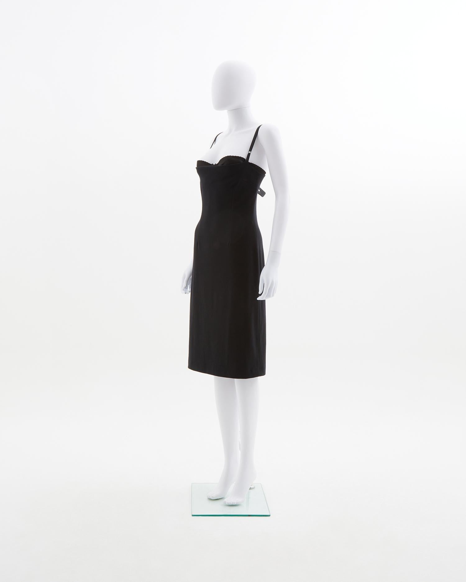 - Early 2000s
- Sold by Skof.Archive
- Above knee-length 
- Black stretch cocktail dress
- Adjustable straps 
- Square neckline 
- Internal lace and silk bra sewn in that playfully pokes out the top of the dress
- Fit to the body

Size : FR 38 - EN