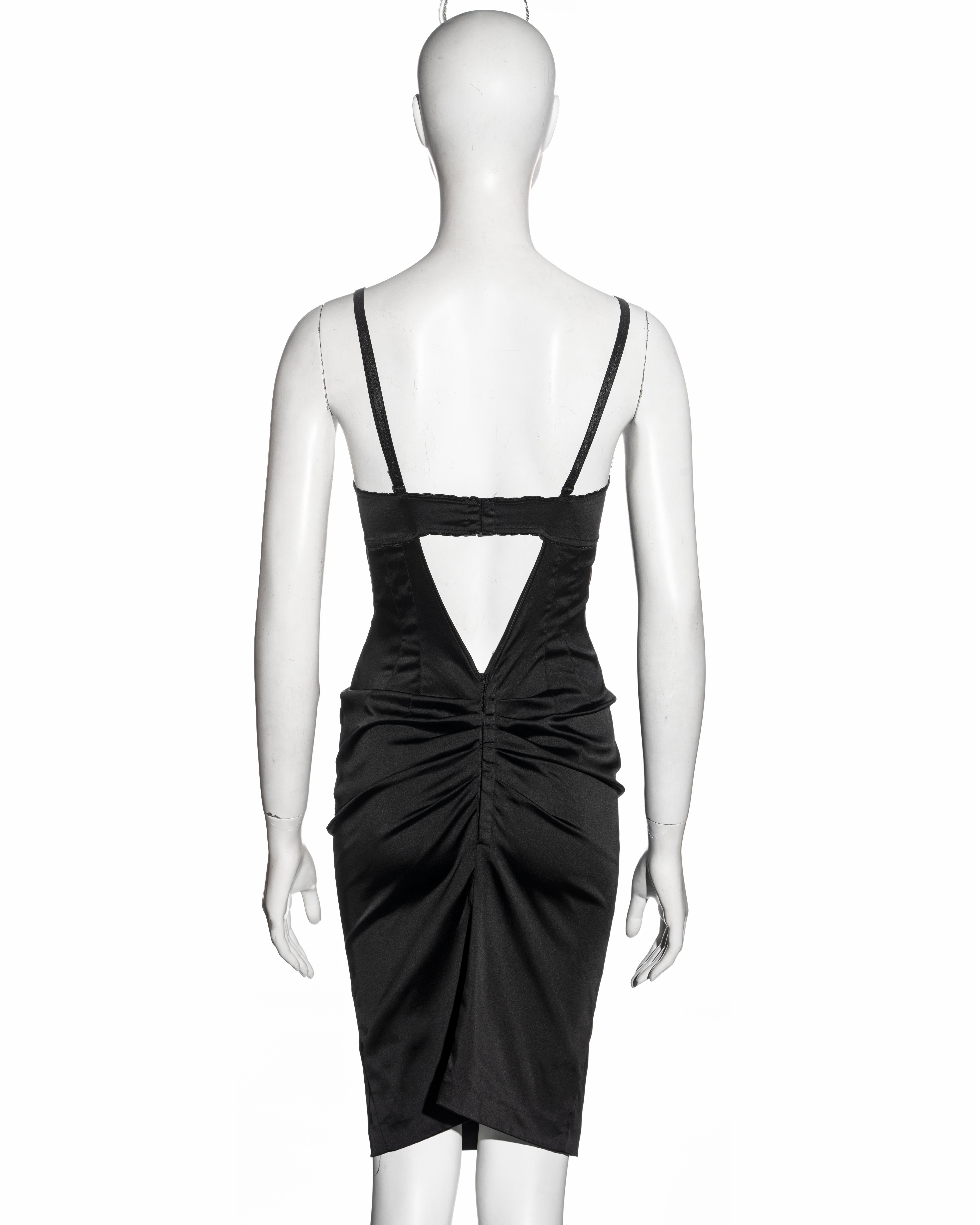 ▪ Dolce & Gabbana black evening dress
▪ Stretch satin 
▪ Attached bra with adjustable shoulder straps 
▪ Low back 
▪ Ruched center-back seam with corset style hooks at the opening 
▪ IT 42 - FR 38 - UK 10 - US 6
▪ Fall-Winter 1998
▪ 80% Acetate, 13%