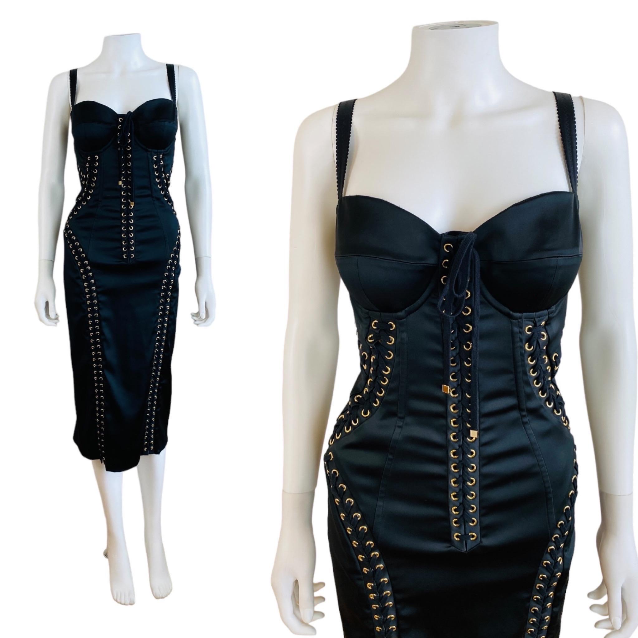 Gorgeous 2019 Dolce + Gabbana corset style dress (shown pinned to mannequin)
Black silk + elastane fabric
Bustier bra style bust with fitted + padded bust cups
Wide adjustable shoulder straps
Wiggle style fit with gold grommets + lacing details