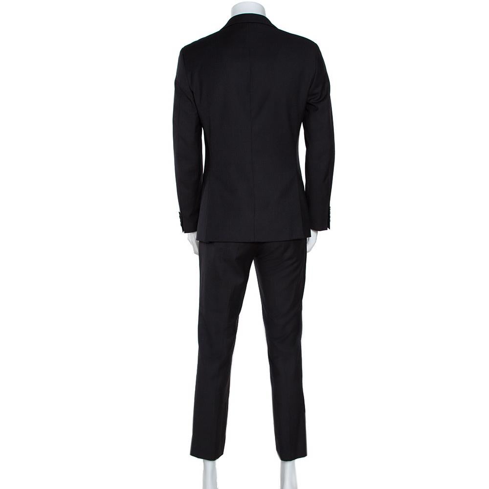 Walk into any formal gathering with style in this suit from Dolce & Gabbana. It comes tailored from quality materials in a black shade. The blazer comes with notched lapels, two front buttons and pockets, and the matching pants come with front zip