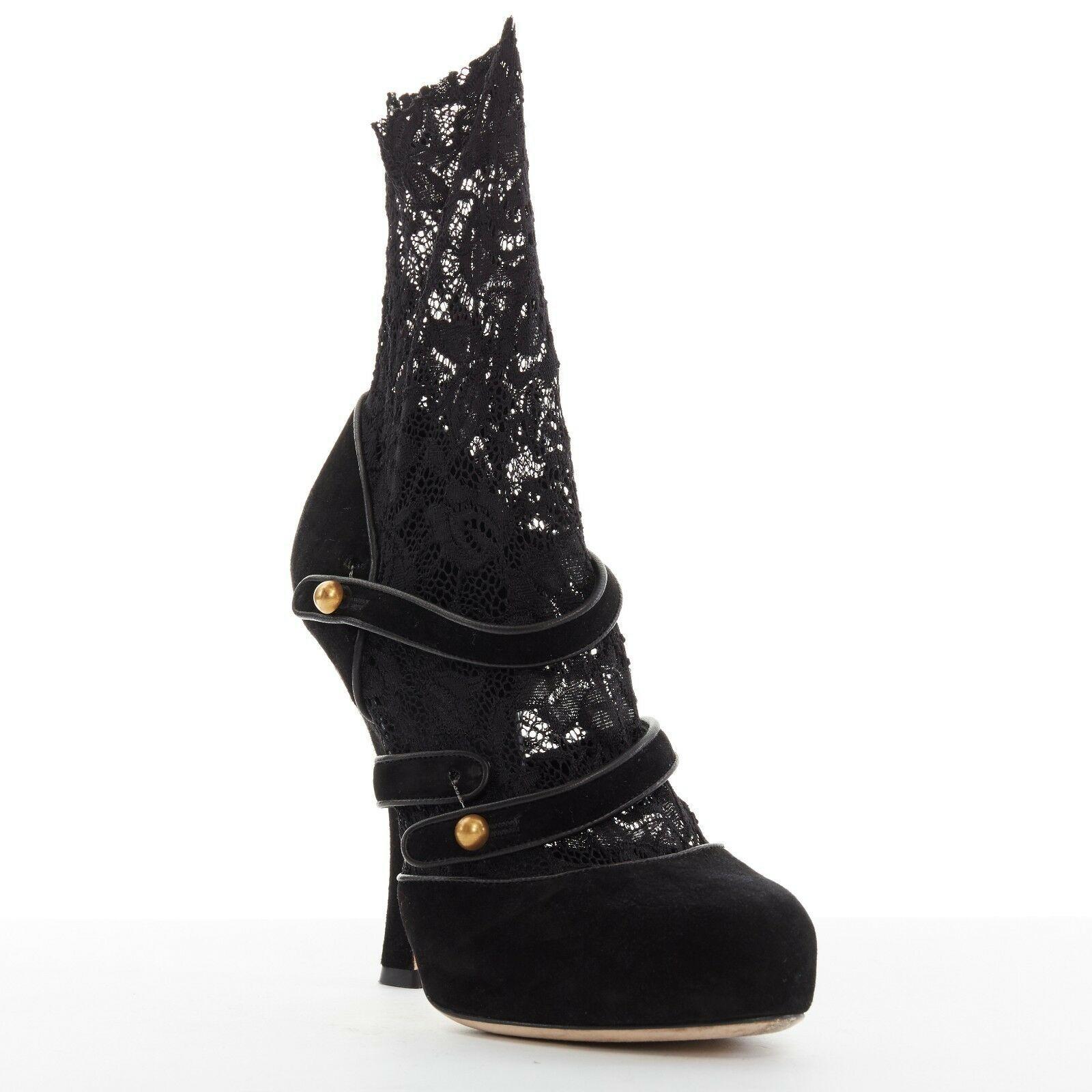 DOLCE GABBANA black suede leather floral lace sock strappy high heel EU38 US8
DOLCE &GABBANA
Black suede leather upper. Gold-tone rounded button closure. 
Dual strap front. Black floral lace sock insert. Curved heel. 
Made in Italy.

CONDITION
Very