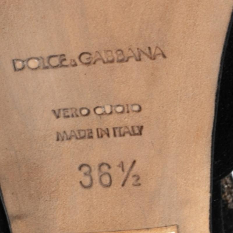 Embrace an exquisite look with this pair of black sandals from the house of Dolce & Gabbana. Defined by a T-bar design and a suede exterior, the pair features a peep-toe silhouette and 11 cm heels that uplift your poise with grace. They make for a