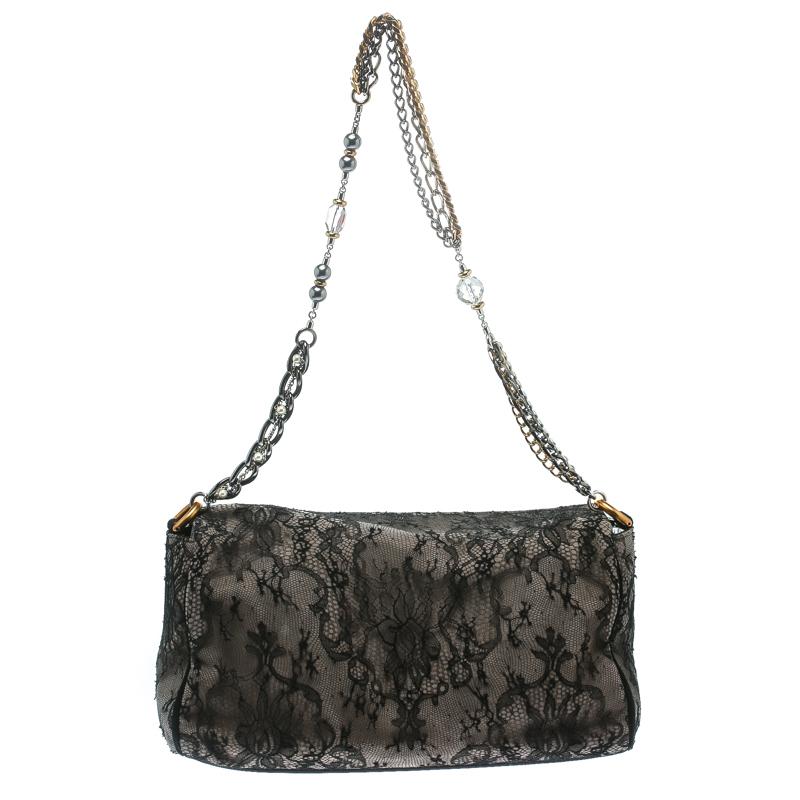 Stylish and handy, Miss Charles shoulder bag from Dolce and Gabbana is crafted from black/taupe lace and suede. The bag comes with a chain link handle and a spacious suede and fabric lined interior that houses a zip pocket. Sophisticated and stylish