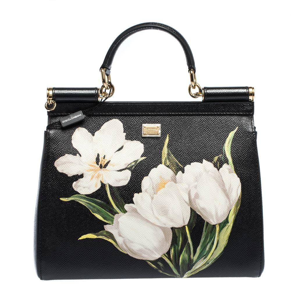 You're sure to be the point of admiration with this exquisite Dolce & Gabbana Miss Sicily bag. Featuring a tulip print, this black dauphine leather bag features a flap with magnetic closure and logo plaque, top handle, adjustable and removable
