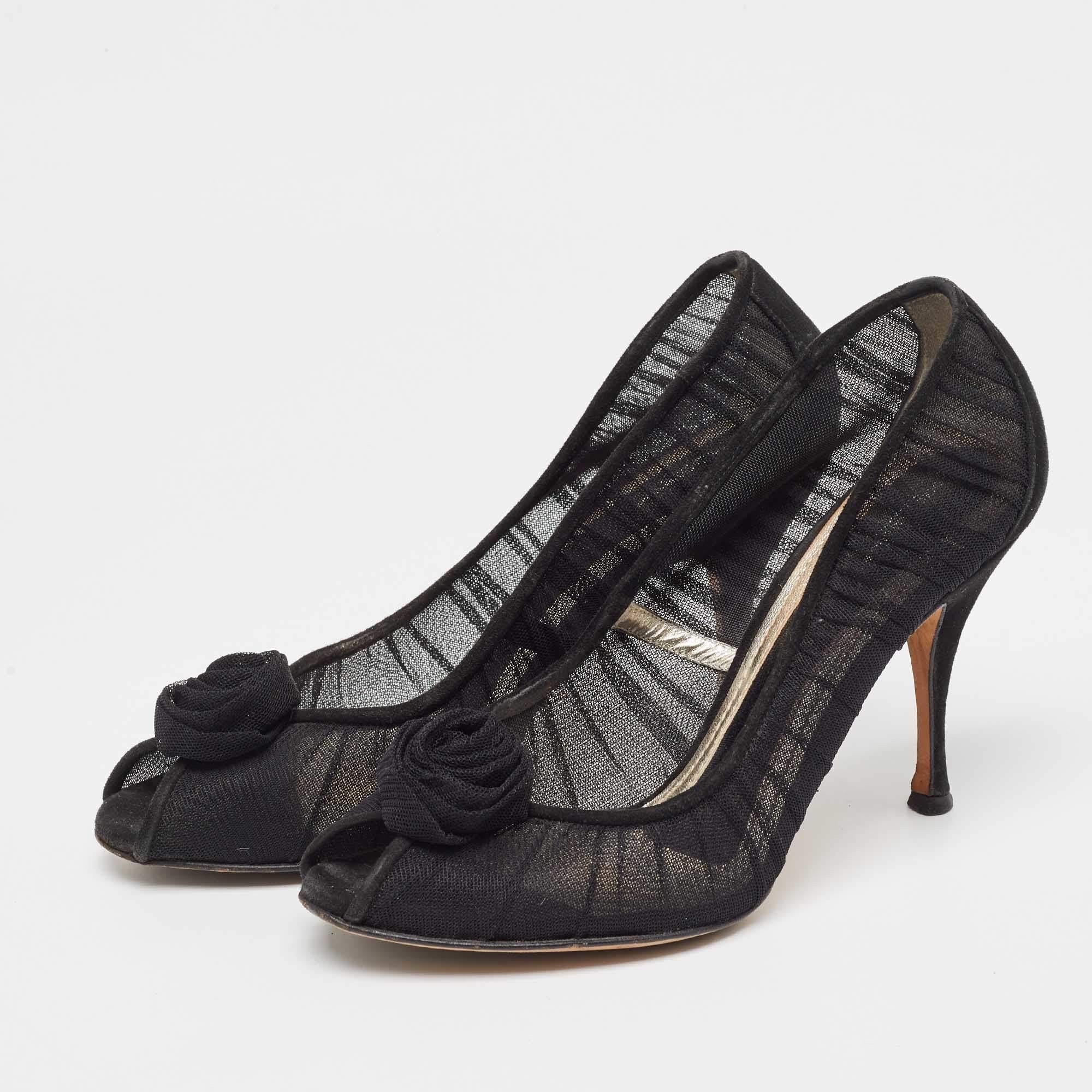 Covered with delicate black tulle these pumps from Dolce and Gabbana deliver a sense of feminine aesthetic and poise with their design. The upper is enhanced with a attached flower appliquÃ© to the front. Step out feeling totally beautiful and
