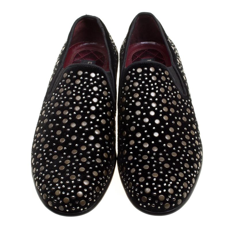Add a pinch of jazz to those muted outfits of yours with these glamorous loafers from the house of Dolce and Gabbana. Embodying the spirit of the label in the truest form, these black velvet shoes are punctuated with gold-tone studs and crystals all