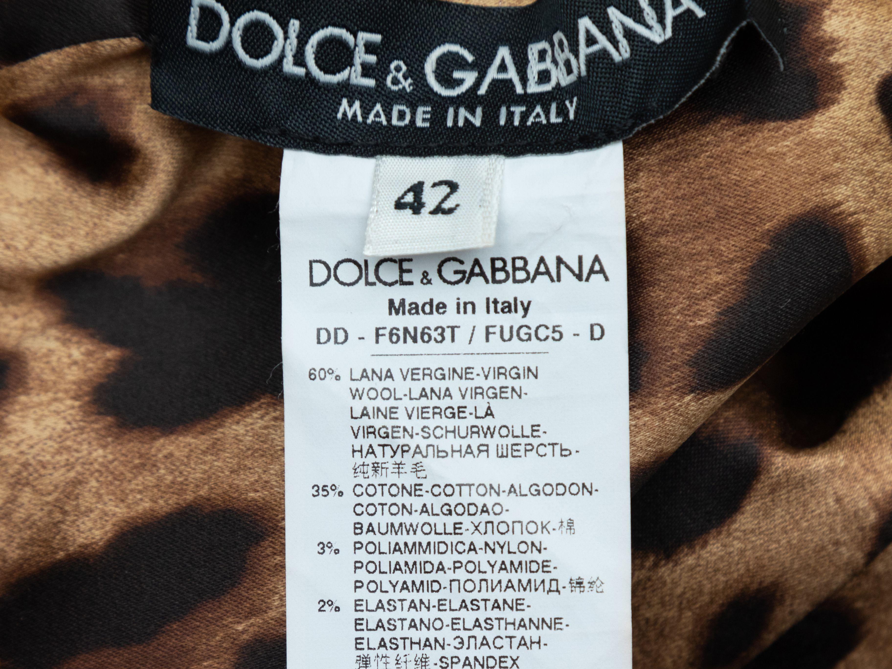 Product Details: Black virgin wool sleeveless dress by Dolce & Gabbana. V-neck. Zip closure at center back. Designer size 42. 32