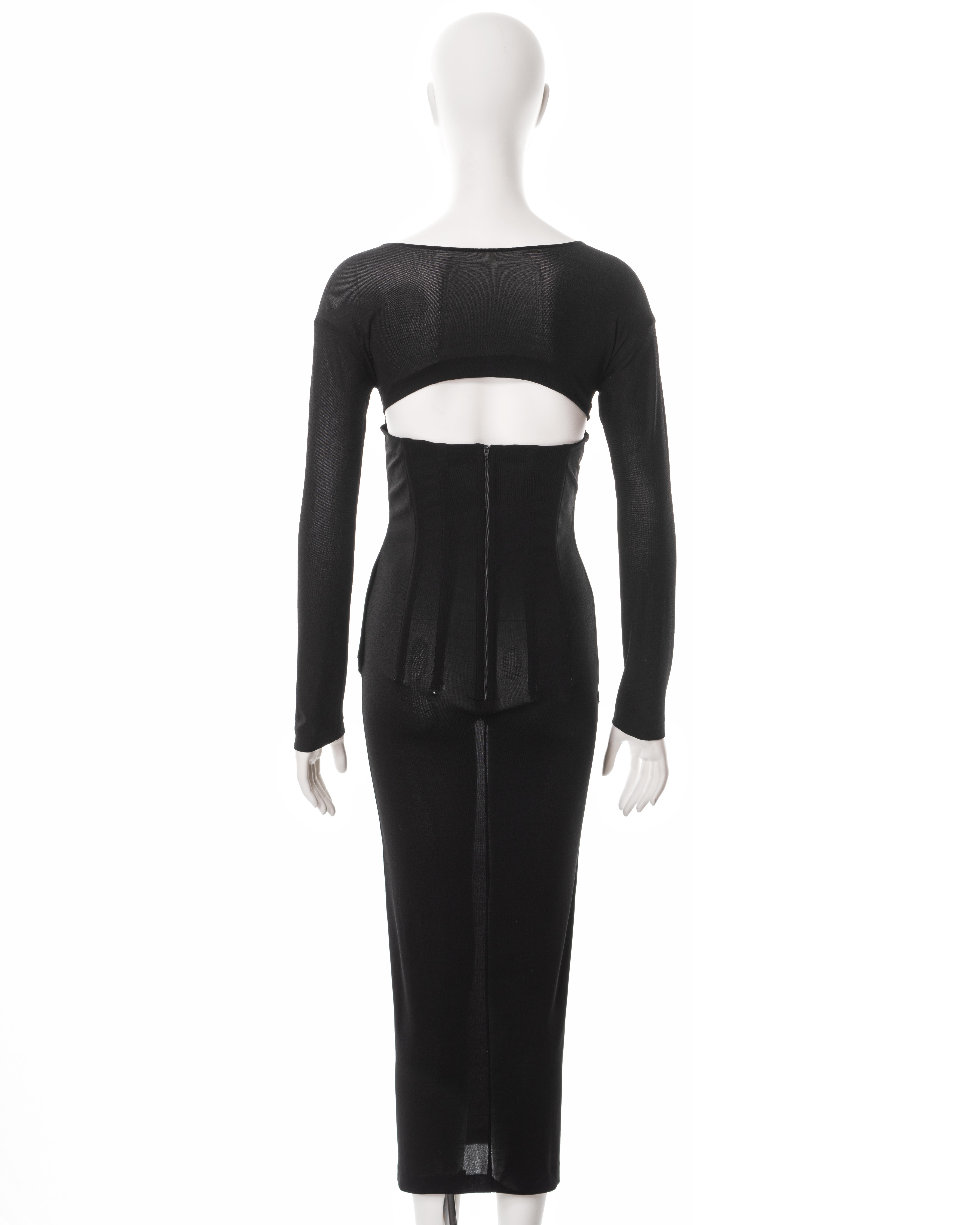 ▪ Dolce & Gabbana black long sleeve evening dress
▪ Spring-Summer 1999
▪ Constructed from a black semi-sheer viscose-lycra mix jersey 
▪ Built-in corset bones 
▪ Long fitted sleeves
▪ Scoop neck 
▪ Centre-back zipper 
▪ Cut-out at the back
▪