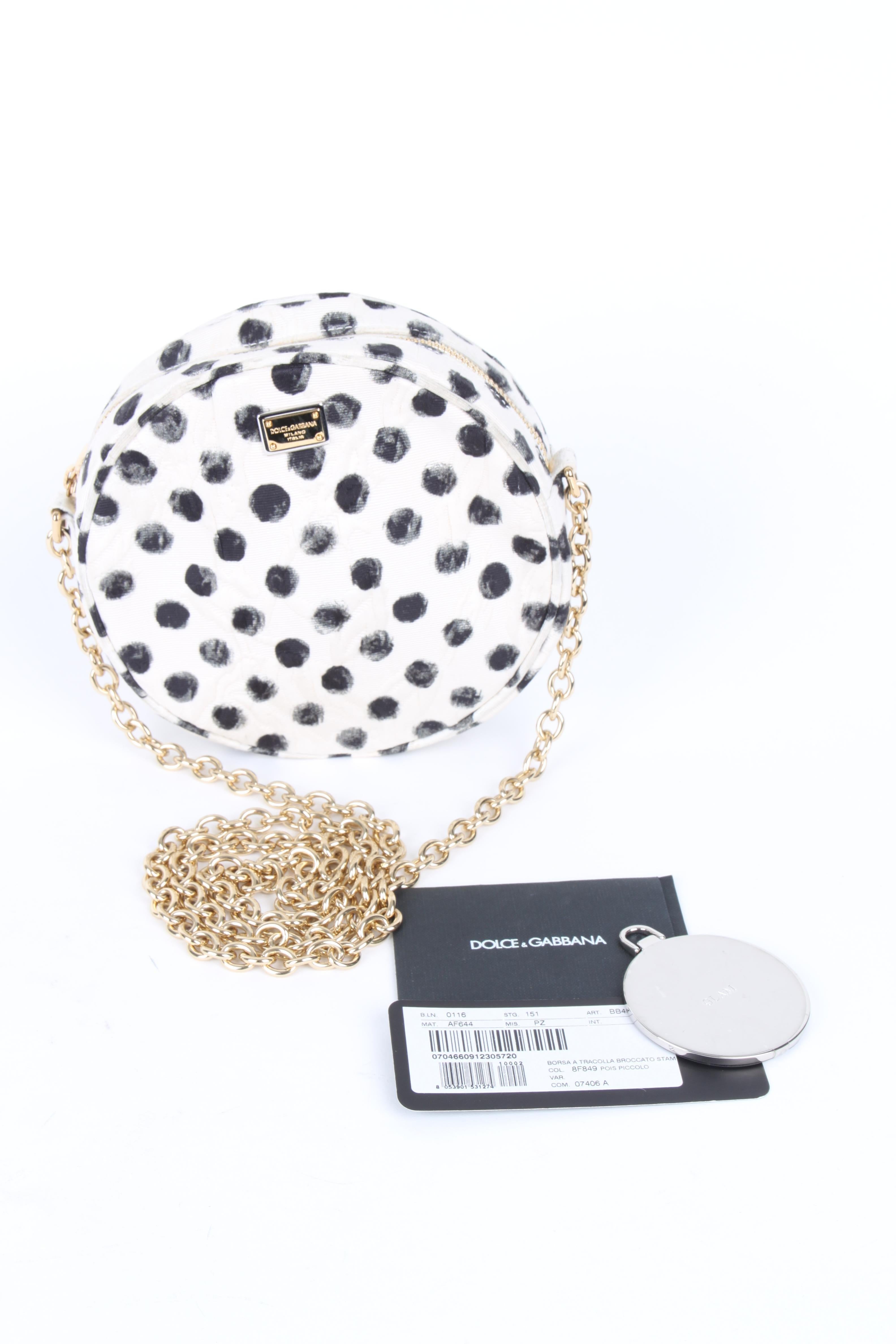 Dolce & Gabbana Glam Polka Dot Black White Cross Body Bag.

Polka-dot jacquard crossbody featuring a golden chain-link shoulder strap, two-tone Dolce & Gabbana logo plate and zip top seals round silhouette.

Metallic chain link shoulder strap.
Zip