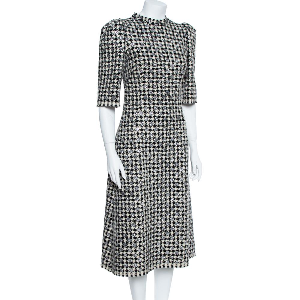 This classy and sophisticated midi dress by Dolce & Gabbana is made for a fashionista like you! Tailored from a wool blend, the dress features the houndstooth pattern and stunning glitter details all overall. Style it with a metallic clutch and high
