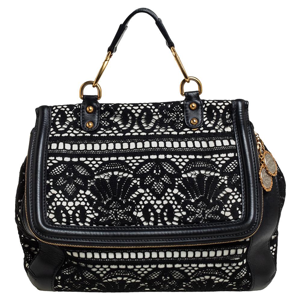 The iconic Miss Sicily bag by Dolce & Gabbana is named after Domenico Dolce's native land and exhibits the aesthetic of Italian glamour. The neat silhouette is made from white leather then overlaid with dainty black lace for a feminine appeal. It