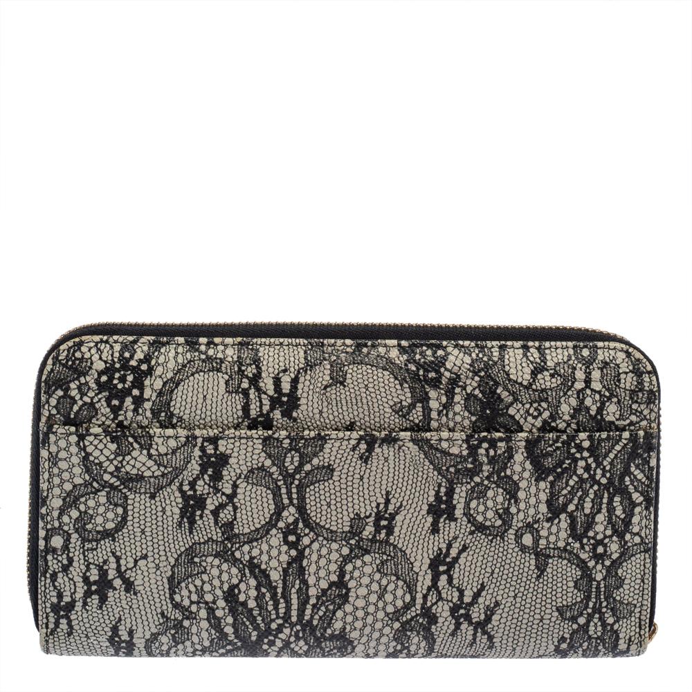 A stylish and feminine design, this Dolce & Gabbana wallet is a wardrobe staple. Made in Italy from leather, it flaunts a lace print all over. Multiple card slots and compartments are secured by a zip-around closure. The creation is finished off