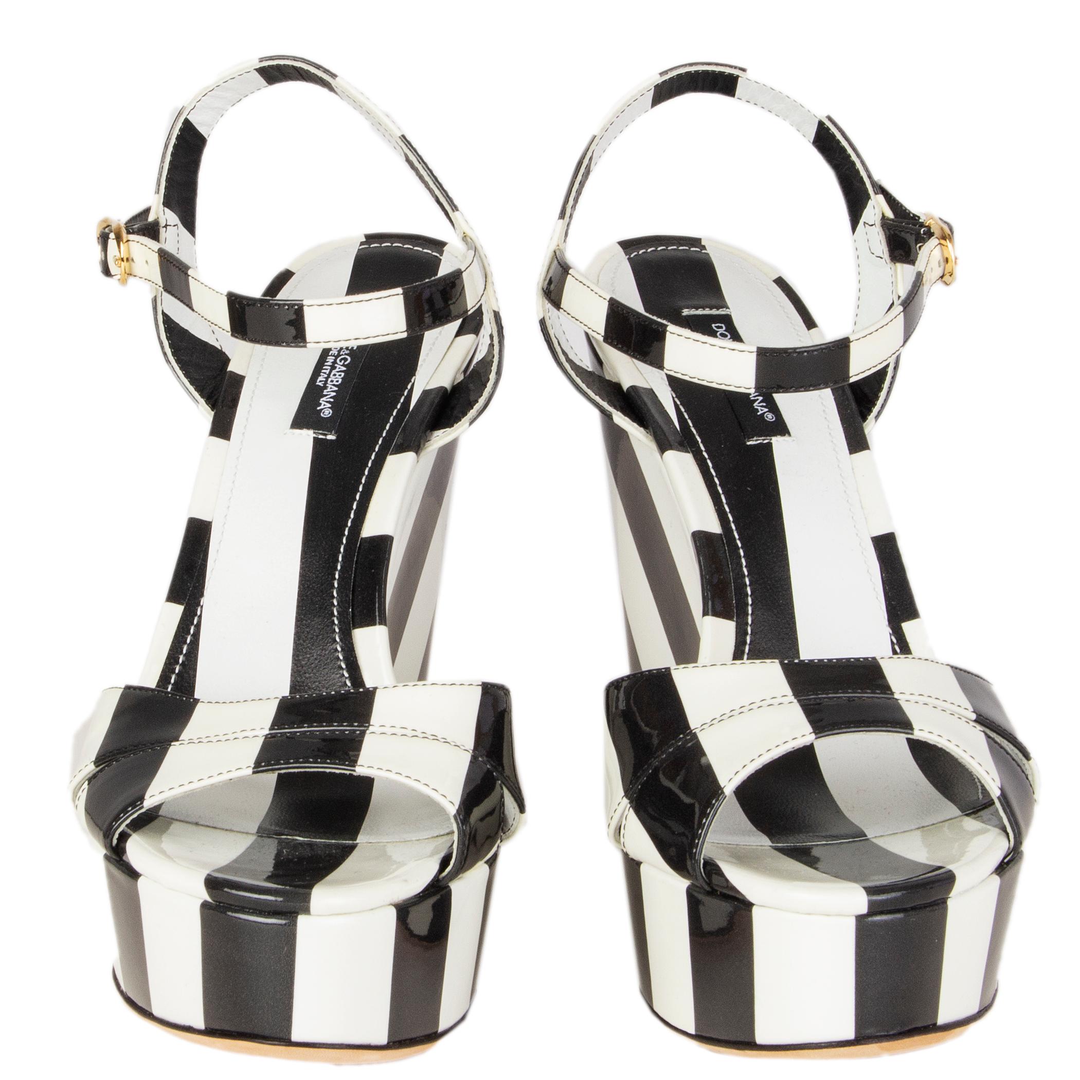 100% authentic Dolce & Gabbana striped wedges in black and white patent leather. Buckle fastening at ankle. Brand new. 

Measurements
Imprinted Size	38
Shoe Size	38
Inside Sole	24.5cm (9.6in)
Width	7.5cm (2.9in)
Heel	13cm (5.1in)
Platform:	4cm