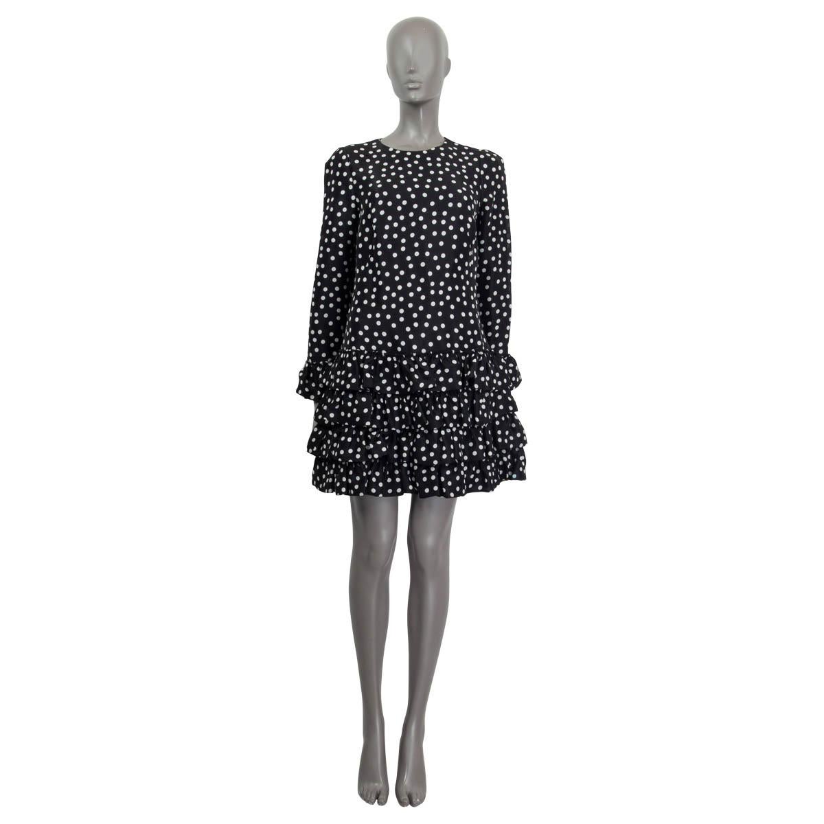 100% authentic Dolce & Gabbana ruffled polka-dot mini dress in black and white silk (100%). Has long sleeves and ruffled cuffs. Opens with a concealed zipper and a hook on the back. Lined in black silk (93%) and elastane (7%). Has been worn and is