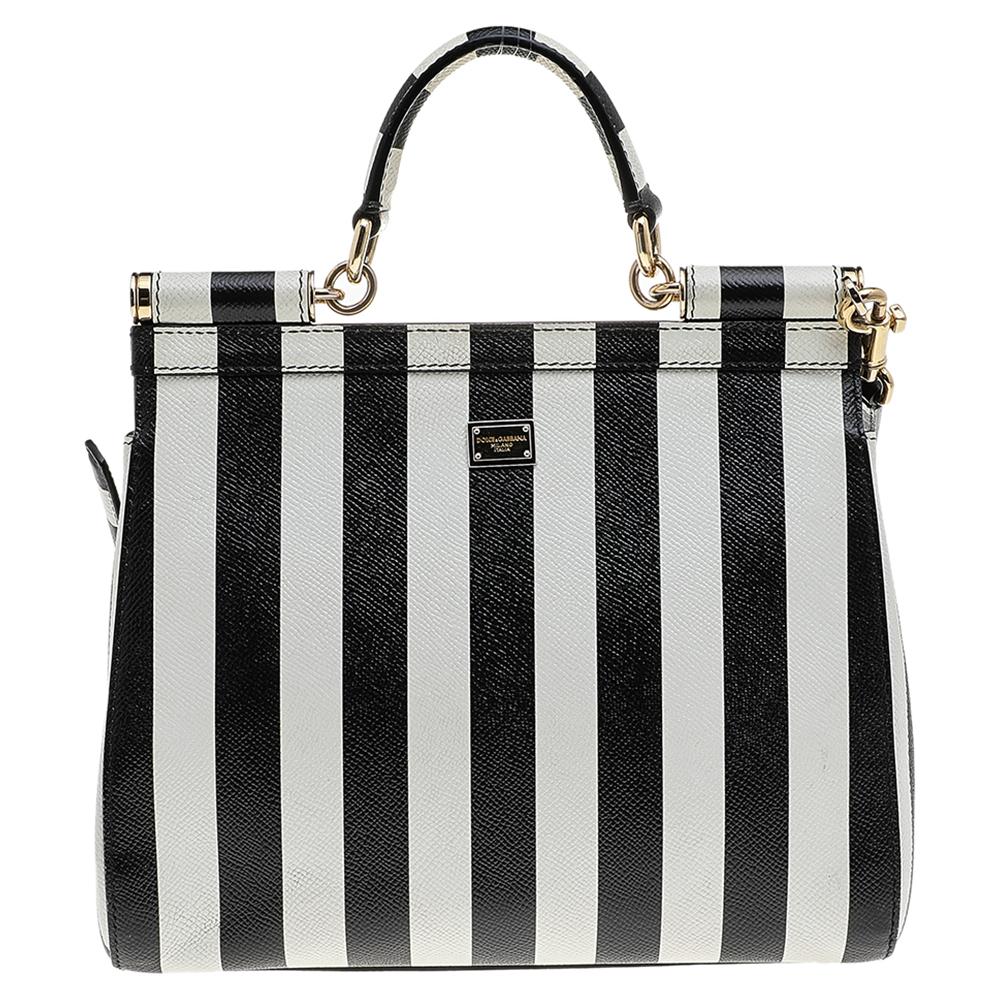 The iconic Miss Sicily bag by Dolce & Gabbana is named after Domenico Dolce's native land and exhibits the aesthetic of Italian glamour. The neat silhouette is made from leather and features stripes all over and a front flap. The creation is