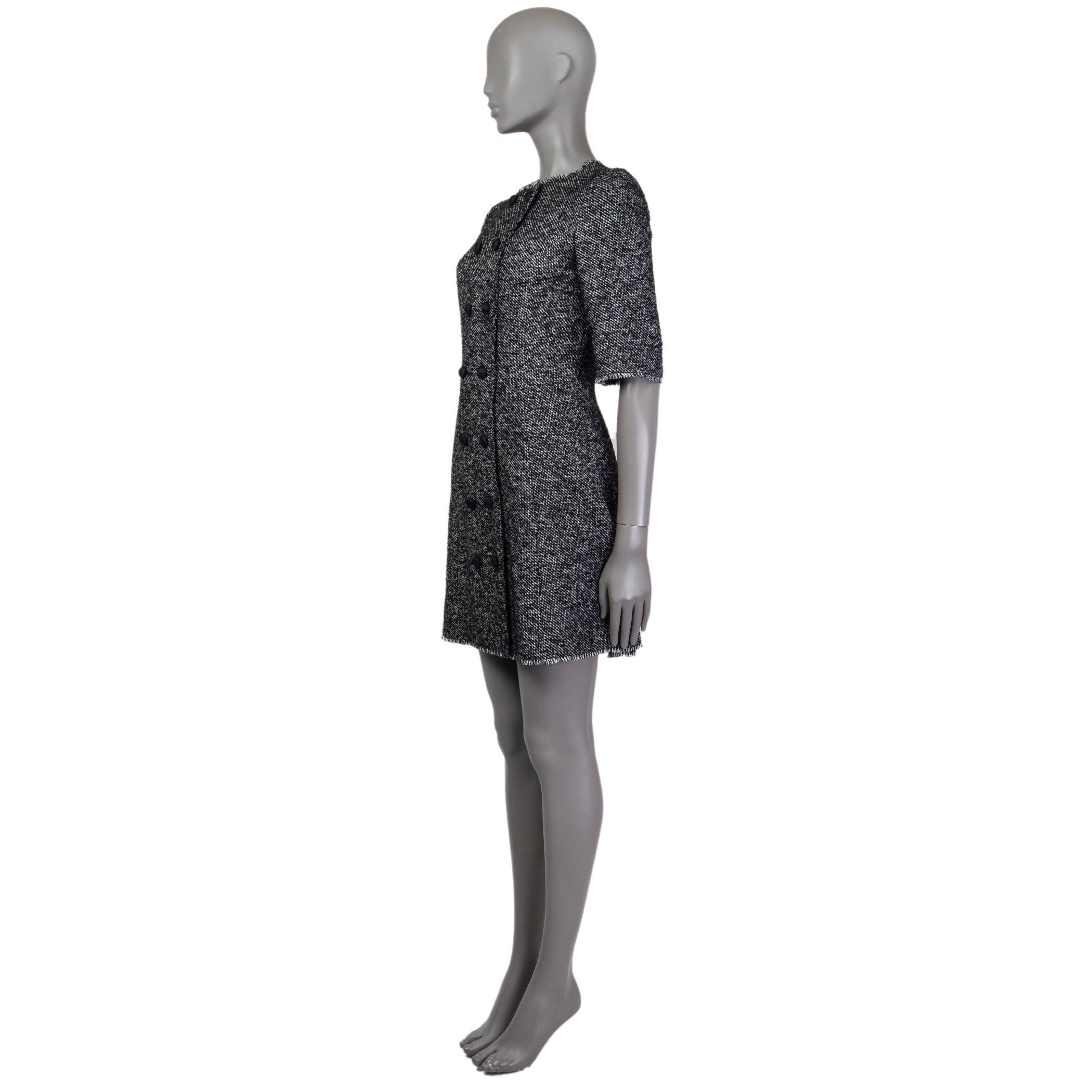 Dolce & Gabbana double-breasted tweed dress in black and white acrylic (49%), polyester (25%), wool (20%), other (4%), and nylon (2%). With crew neck, 3/4 sleeves, decorative fabric-lined buttons on the front, and fringed trims. Closes with