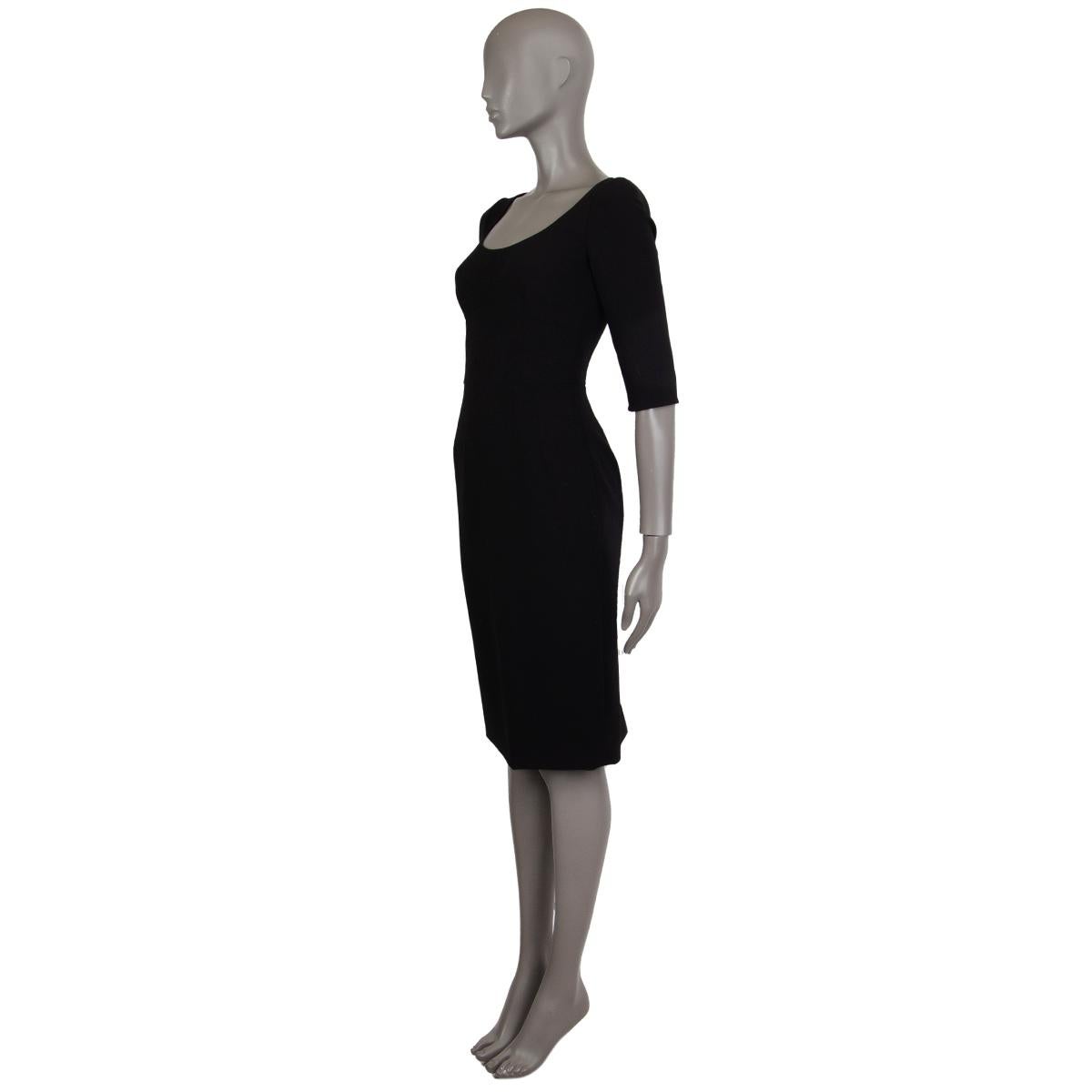 Dolce & Gabbana classic sheath dress in black missing tag (probably wool blend) with a detailed seamed top, round-cut neckline, fitted silhouette, 3/4 sleeve length and slit in the back. Closes with a concealed zipper in the back. Lined in black