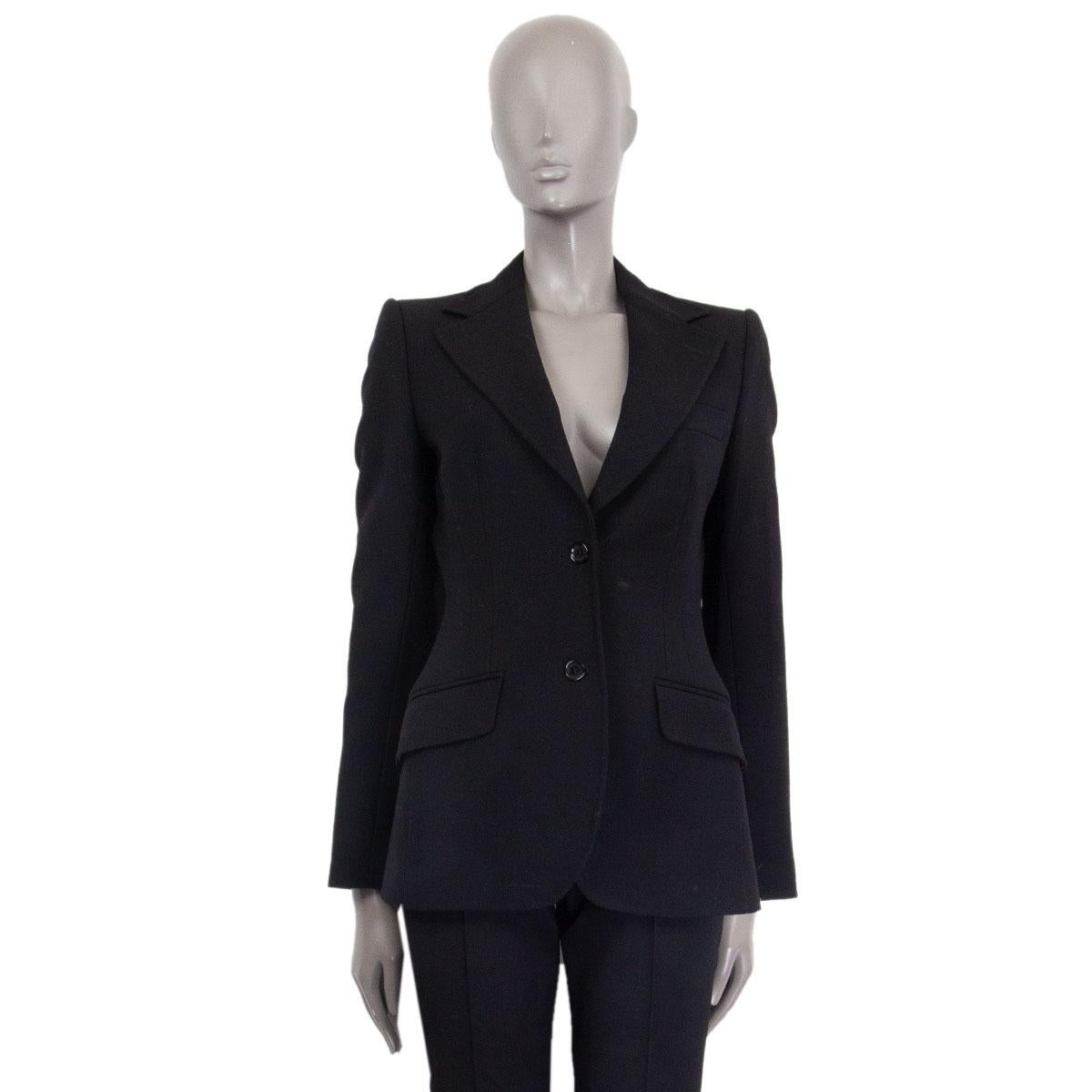 Dolce & Gabbana classic single breasted blazer in black virgin wool (100%) with a notch collar, one chest pocket and two front decorative flap pockets. Closes on the front with buttons. Lined in brown and black leopard print viscose. Has been worn