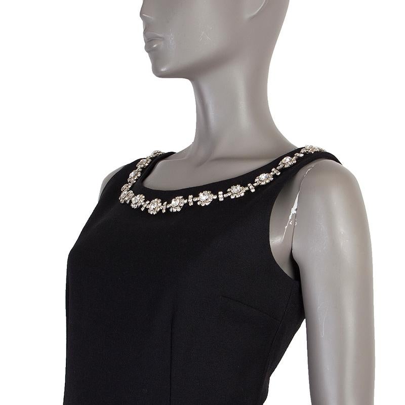 Dolce & Gabbana sheath dress in black virgin wool (80%), nylon (15%), and elastane (5%). With rhinstones around the neck. and slit on the back of the skirt. Closes with one hook and invisible zipper on the back. Lined in black viscose (64%), nylon