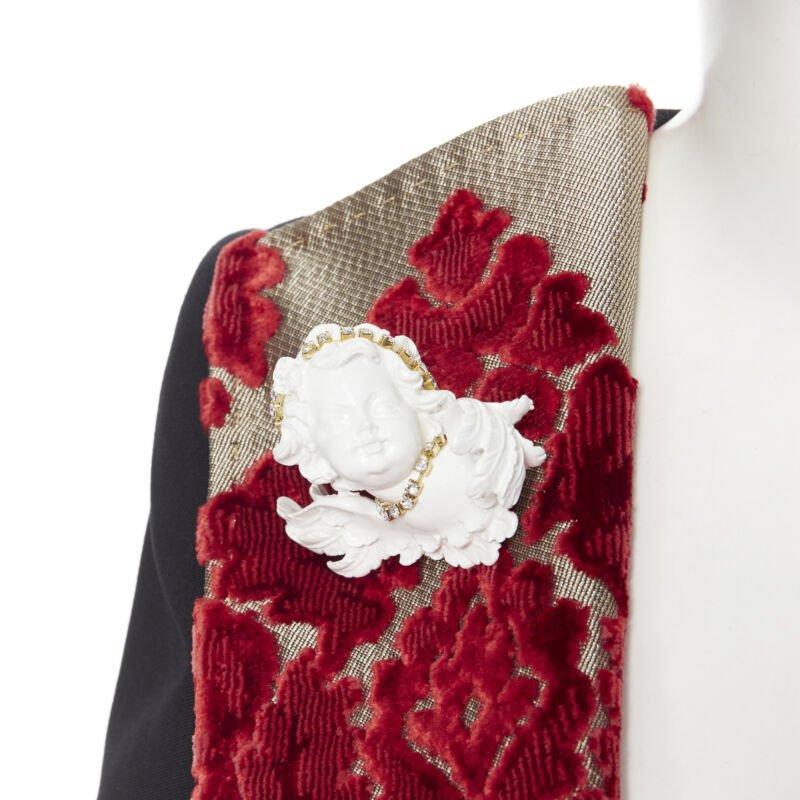 DOLCE GABBANA black wool gold red velvet cherub brooch belted blazer IT40
Reference: CC/MAWG00387
Brand: Dolce Gabbana
Designer: Domenico Dolce and Stefano Gabbana
Collection: Baroque Cherub - Runway
Material: Wool, Blend
Color: Black, Red
Pattern: