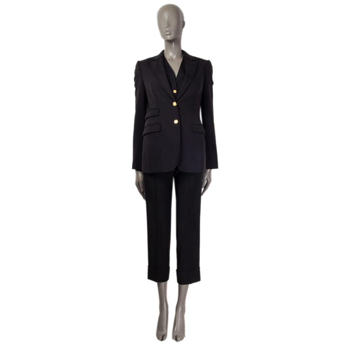 100% authentic Dolce & Gabbana single breasted blazer in black wool (97%) and elastane (3%) with notch collar and three flap pockets on the front. Closes with two gold-tone logo embossed buttons on the front, has buttoned sleeve-hem and a slit on