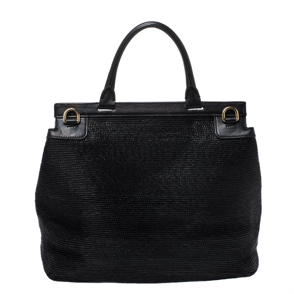 This gorgeous black Miss Sicily satchel from Dolce & Gabbana is a handbag coveted by women around the world. It has a well-structured design crafted from woven straw and leather and a flap that opens to a compartment with fabric lining and enough