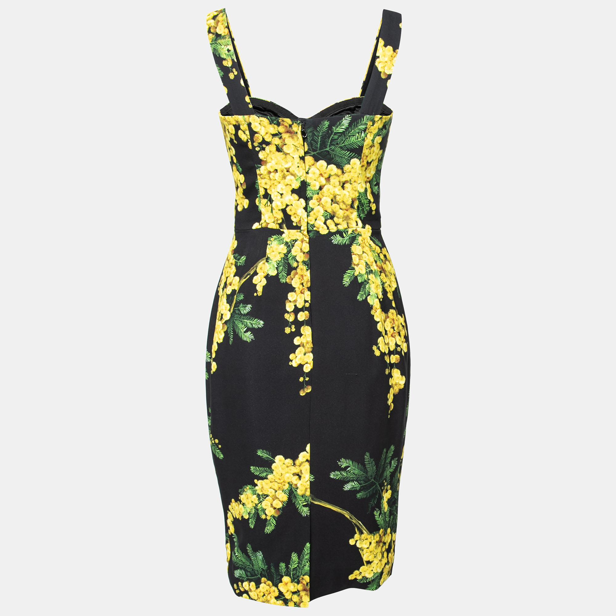 Dolce & Gabbana's beautiful dress will spring you right into the warm memories of summer! Endowed with Mimosa floral prints, this black-yellow silhouette exhibits broad shoulder straps and a bustier fit. A zipper is added for fastening. Style this