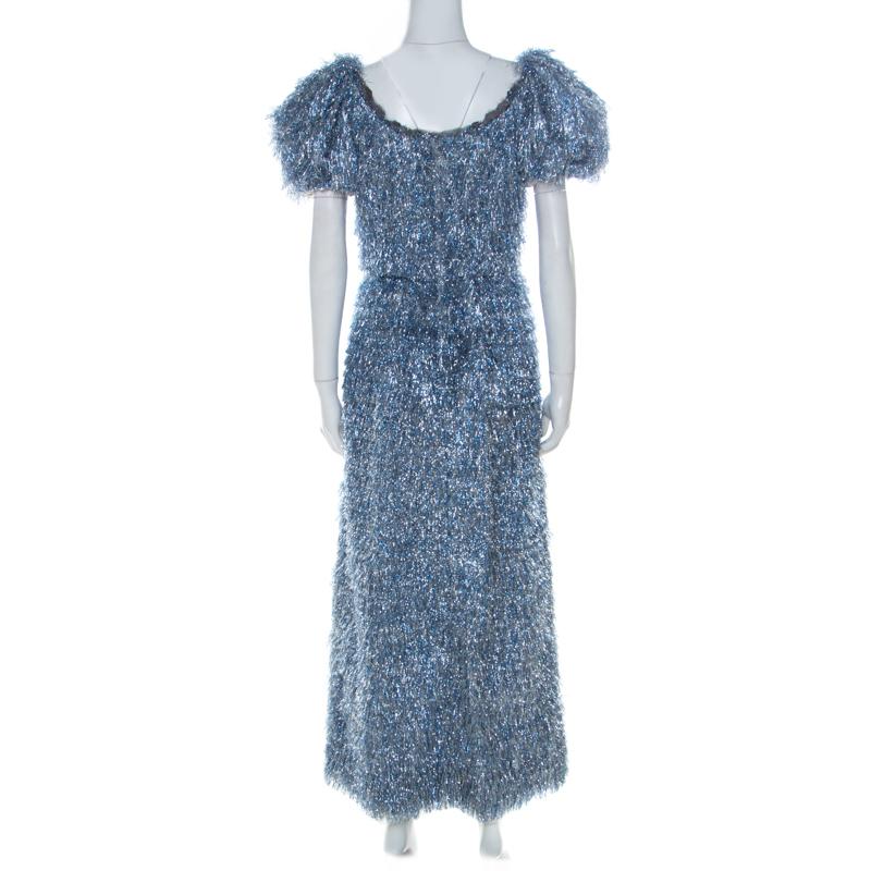 Feminine and beautiful, this Dolce & Gabbana ensemble is a true example of the brand's bold designs. This blue and silver dress has a comfortable fit and an elegant appeal to suit your evening look needs. Masterfully tailored with V-neckline, puffed