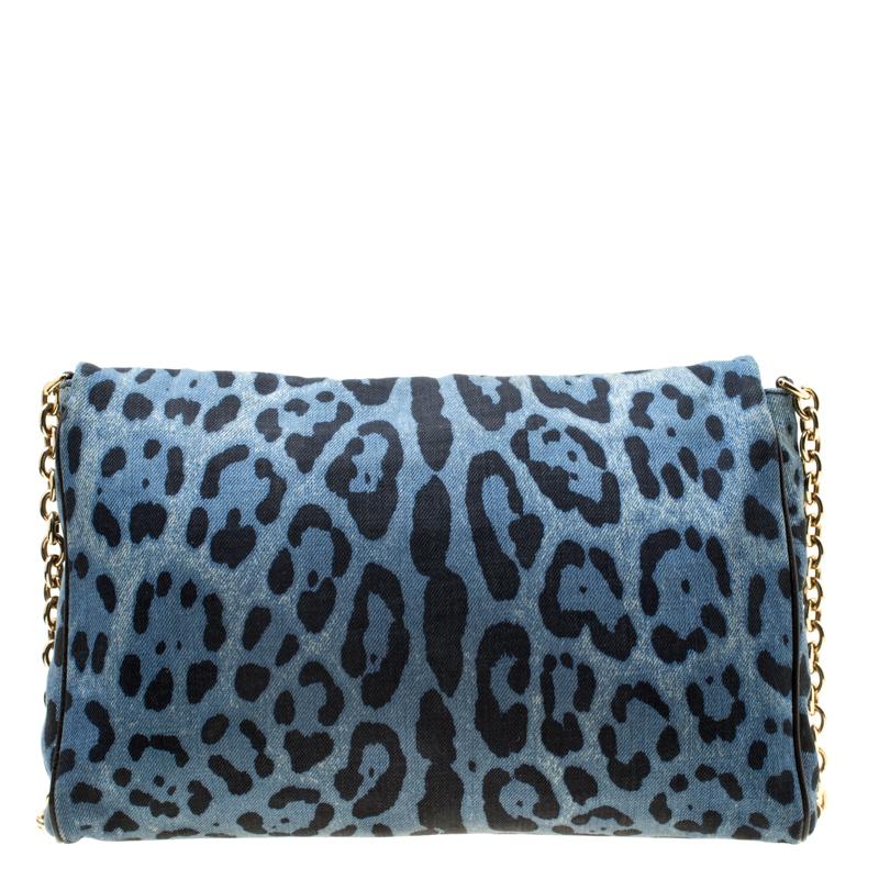 The leopard print denim shoulder bag from Dolce and Gabbana features a chain-link shoulder strap, gold-tone brand logo plaque at the front, a functional design, and full-flap closure. The spacious fabric-lined interior houses a zip pocket within the