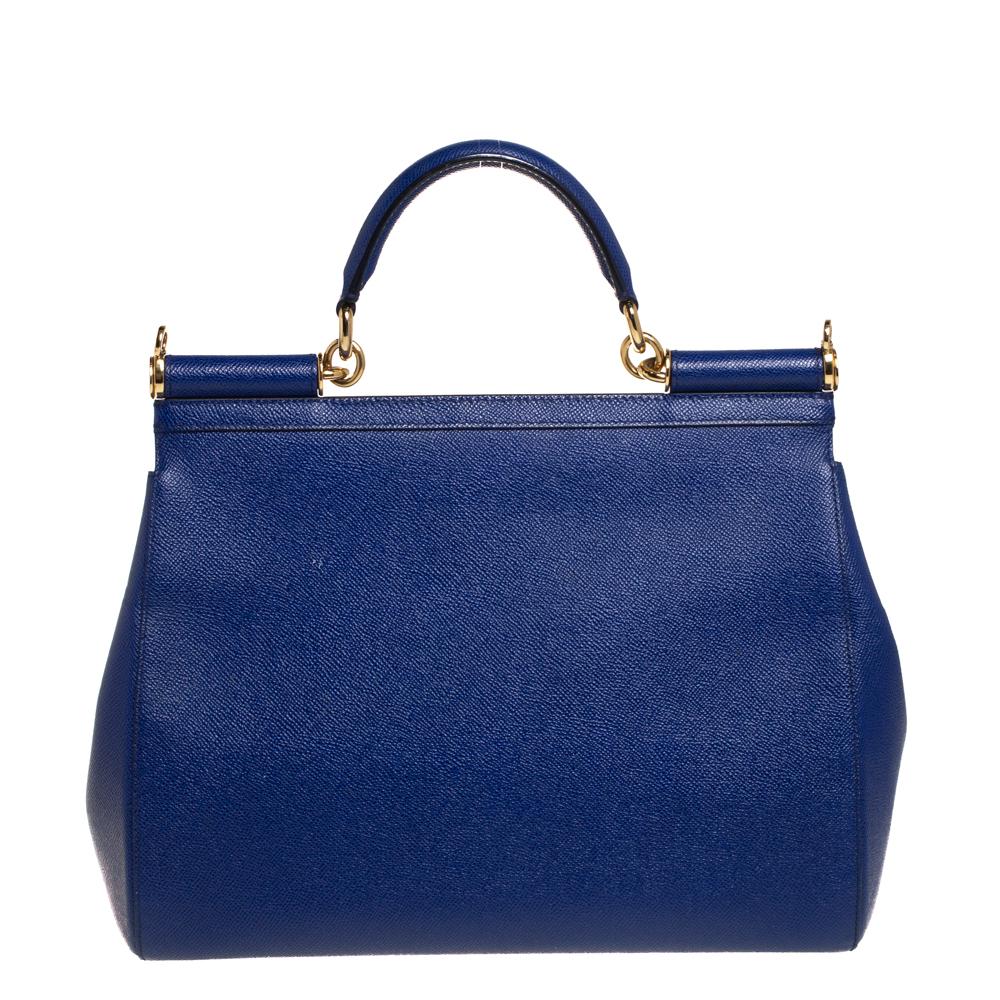 The iconic Miss Sicily bag by Dolce & Gabbana is named after Domenico Dolce's native land and exhibits the aesthetic of Italian glamour. The neat silhouette is made from leather in a blue shade and features a front flap accented with the signature