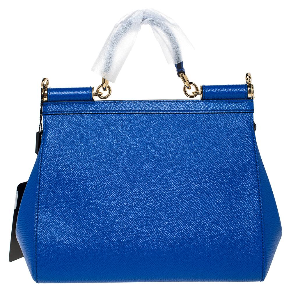 This gorgeous blue Miss Sicily satchel from Dolce & Gabbana is a handbag coveted by women around the world. It has a well-structured leather body and a flap that opens to an interior enough space to fit your essentials. The bag comes with a top