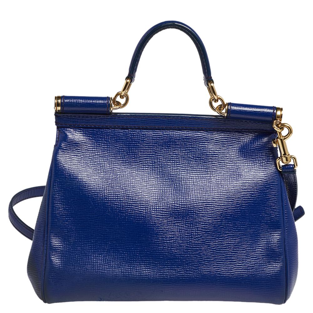 The iconic Miss Sicily bag by Dolce & Gabbana is one of the most loved designs from the brand. The elegant silhouette is made from leather in a blue shade and features a front flap accented with the logo plaque. The creation is complemented with