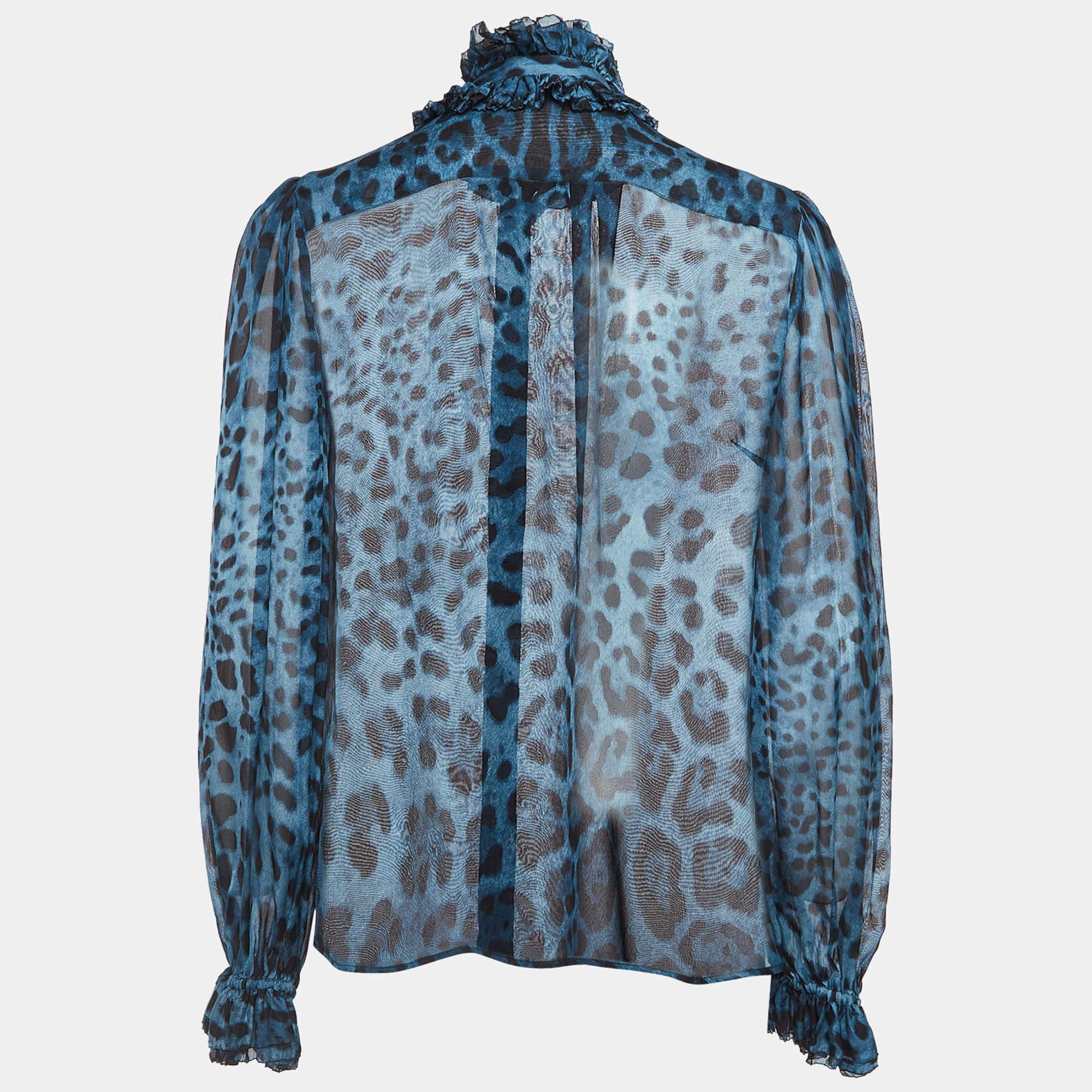 In the Dolce & Gabbana shirt, the feline-inspired motif dances on luxurious silk, exuding a wild yet refined charm. Delicate ruffles cascade along the silhouette, adding a playful flourish to the semi-sheer fabric, a testament to the brand's mastery