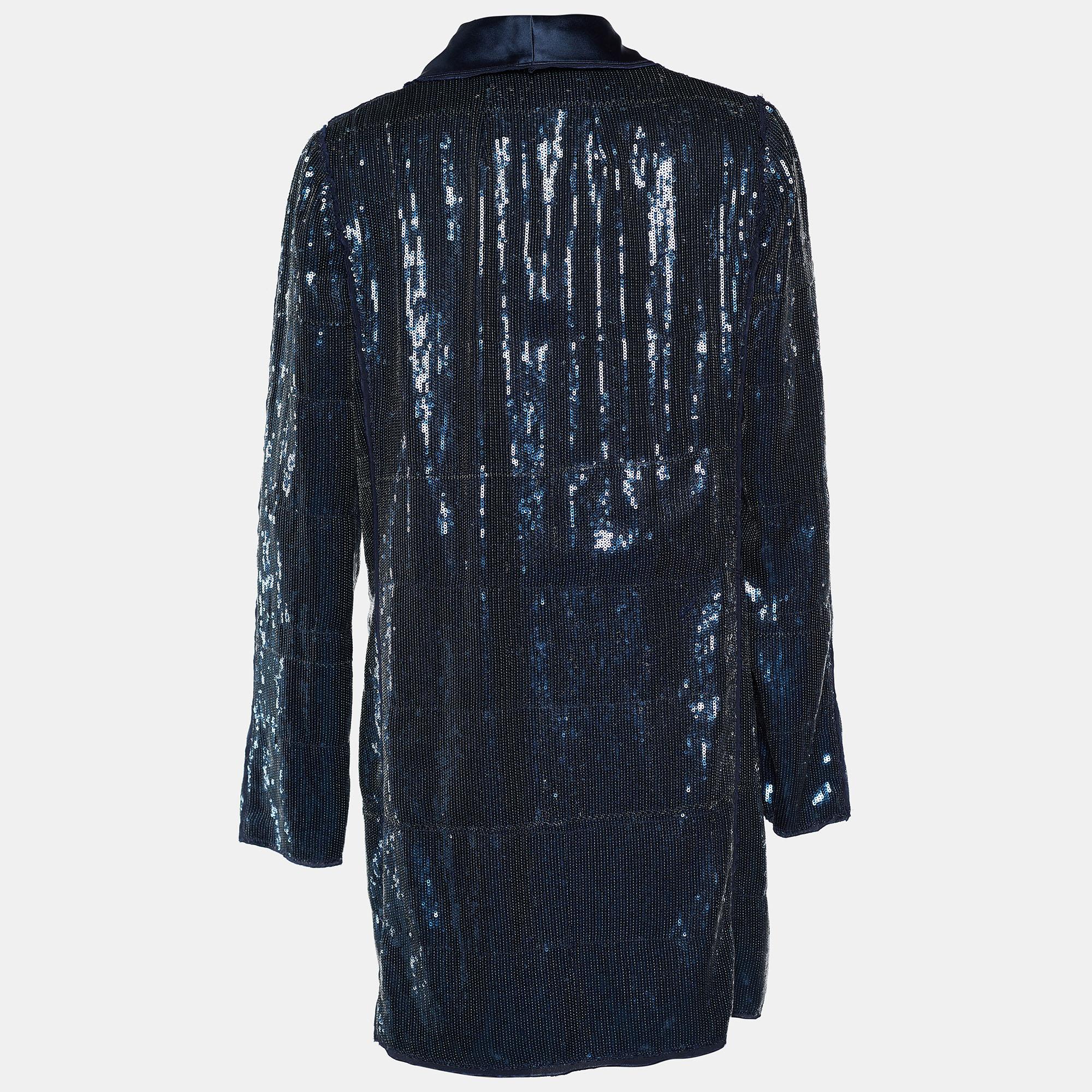 Shine through the evening as you wear this fabulous blazer from the House of Dolce & Gabbana! Doused in sequins, this blue blazer has a long length with a single button closure on the front. It has long sleeves and accommodates two pockets to store