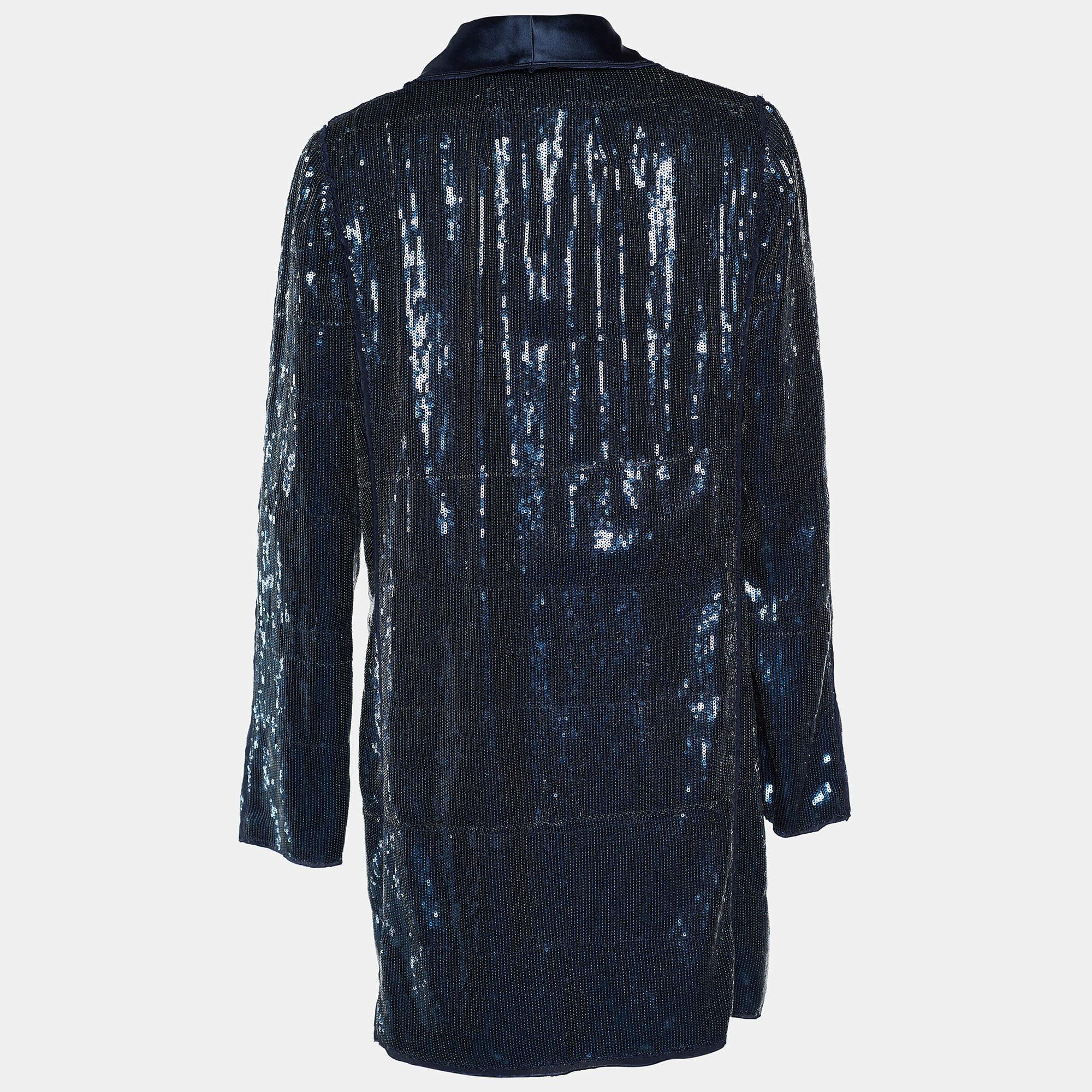 Shine through the evening as you wear this fabulous blazer from the House of Dolce & Gabbana! Doused in sequins, this blue blazer has a long length with a single button closure on the front. It has long sleeves and accommodates two pockets to store