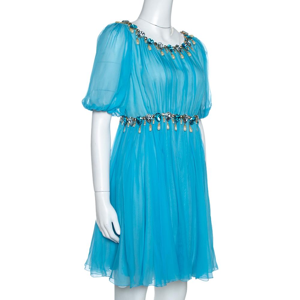 From the house of Dolce & Gabbana, this ensemble is a chic piece to own. It will make sure that you look like a modern day Cinderella! Crafted from luxurious blue silk chiffon, this dress is perfect for evenings. It has a billowy silhouette, short