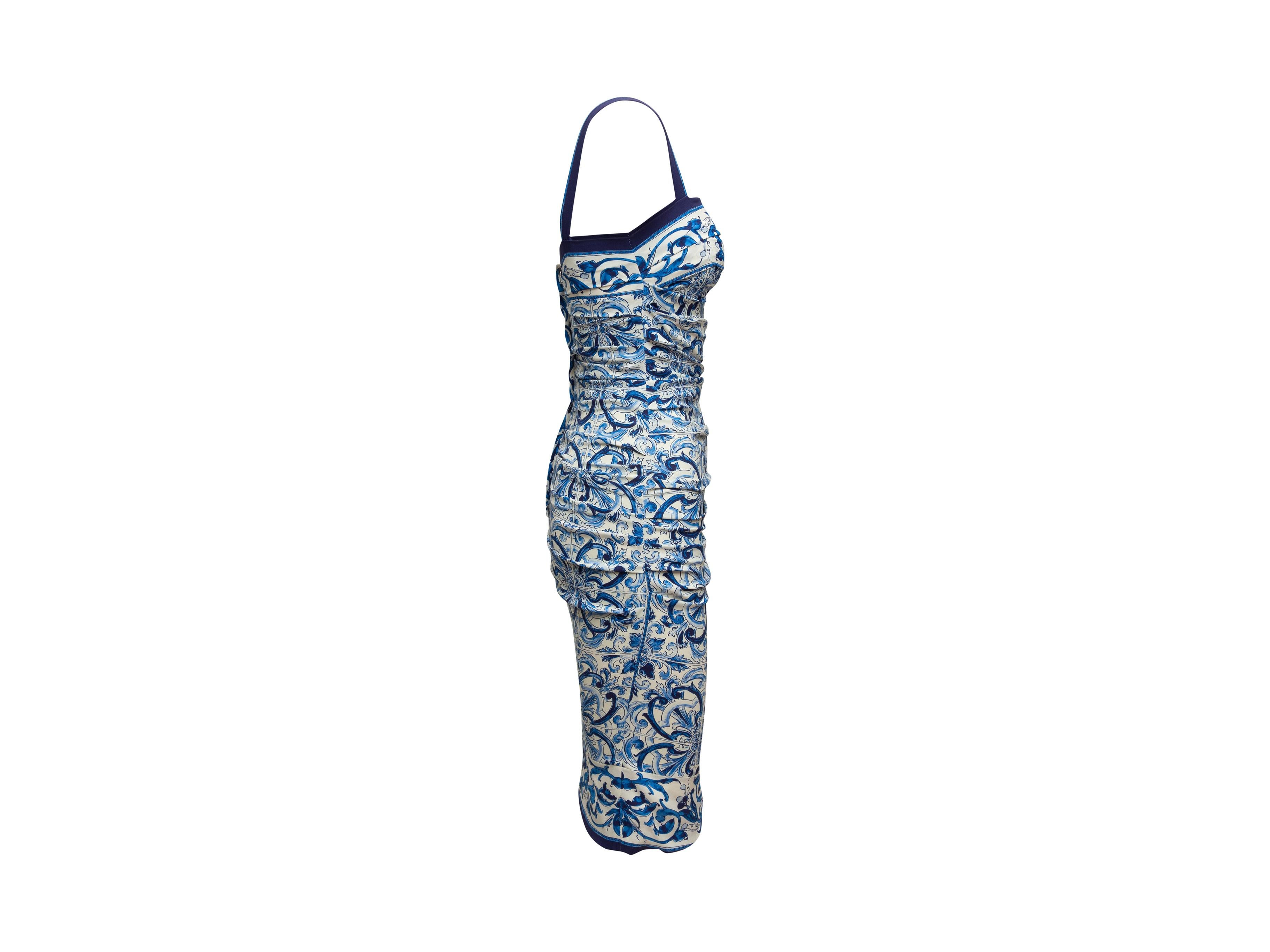 Product details: Blue and white silk sleeveless Majolica print bodycon dress by Dolce & Gabbana. Square neckline. Ruching at sides. Zip closure at back. Designer size 38. 30