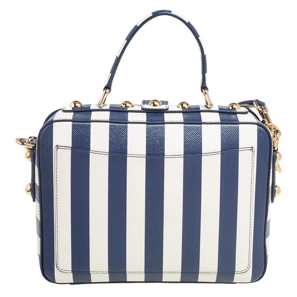 Made from blue & white striped leather, this bag is both reliable and stylish. It comes in a flap style with features such as a top handle, a shoulder strap, gold-tone hardware, and a lined interior. This box bag from Dolce & Gabbana will be a fine
