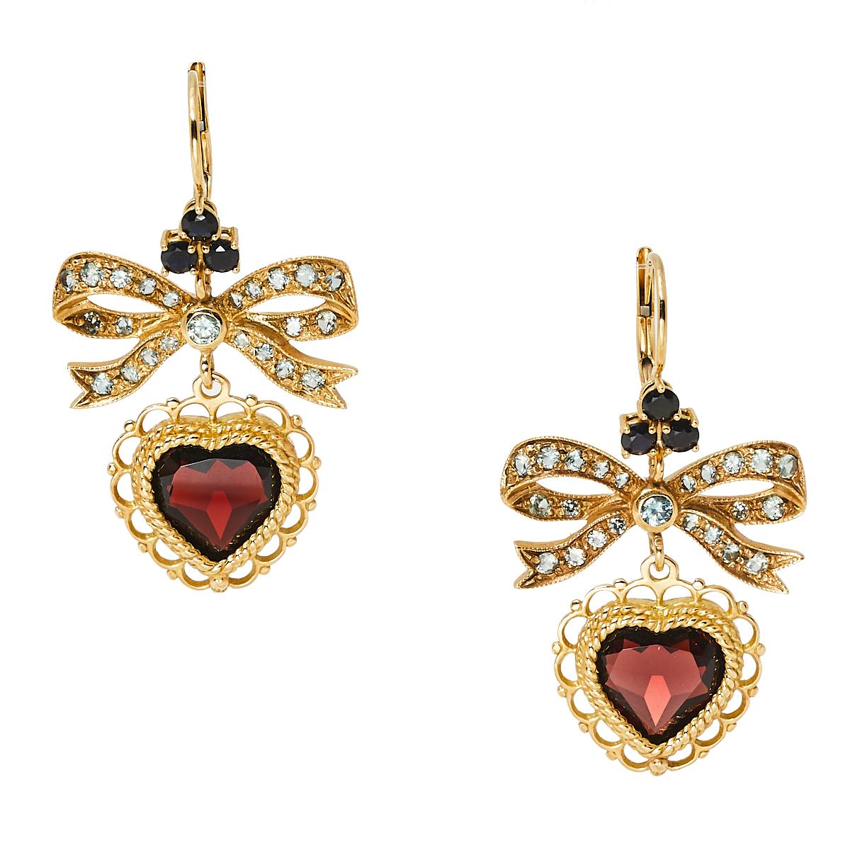 These Dolce & Gabbana earrings feature garnet and sapphire on 18k yellow gold to project a mesmerizing end result. Designed in a dangler style, they are elegant and comfortable. The perfect gift for a jewelry lover or the perfect addition to your