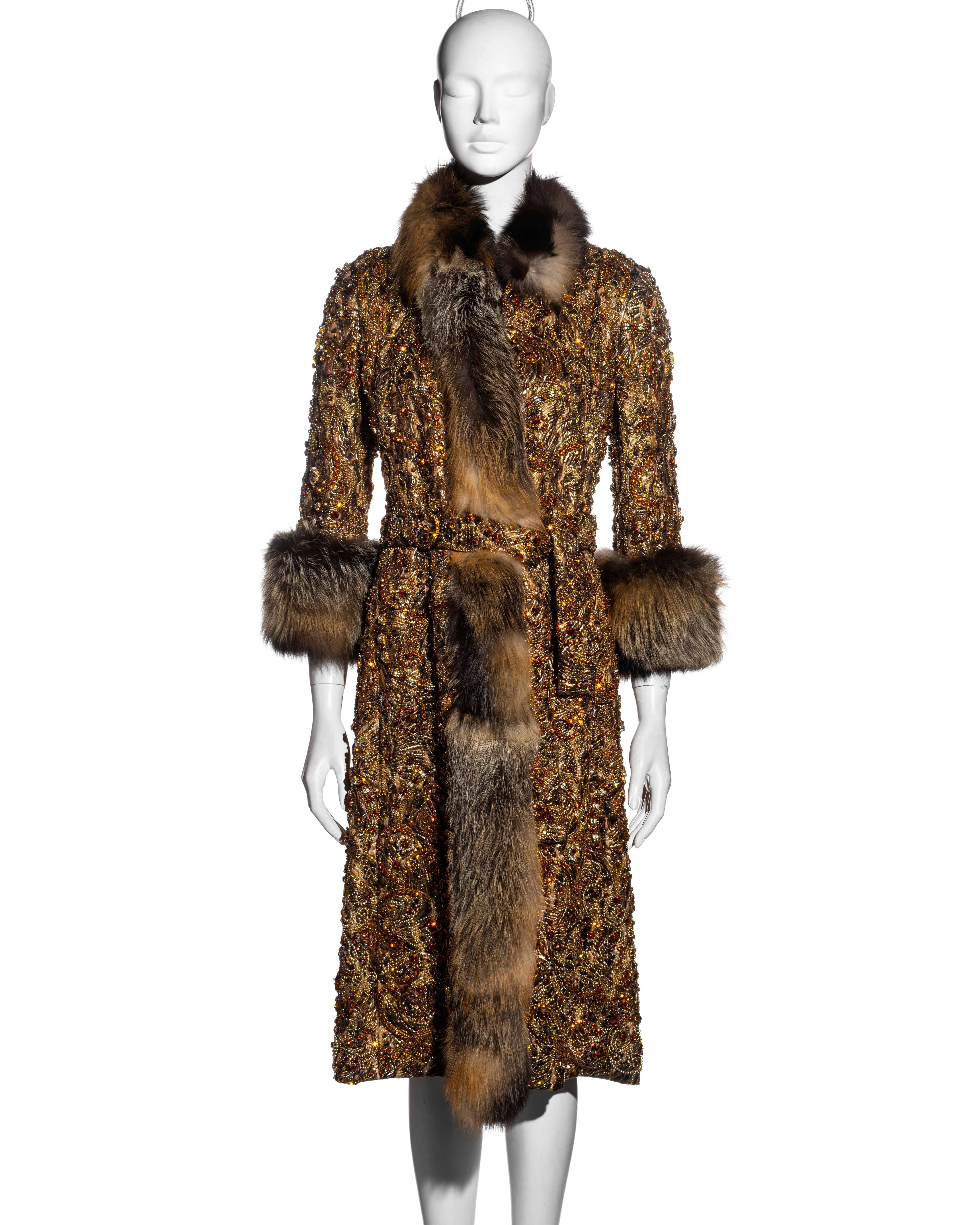 ▪ Dolce & Gabbana brocade and fox fur embellished evening coat
▪ Bronze brocade 
▪ Fox fur trim, collar and cuffs 
▪ Embellished with a plethora of crystals, stones and beads 
▪ Matching embellished belt
▪ Heavyweight 
▪ Lined with black silk
▪ IT